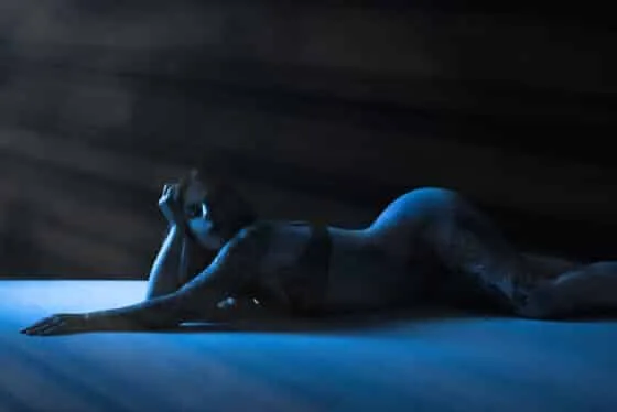 Moody blue silhouette of a reclining female form, photographed by an Austin boudoir photographer | Boudoir Photography Austin | Nerves Before Boudoir Photoshoot