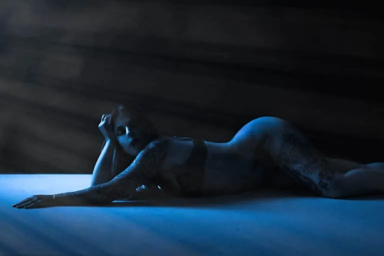 Moody blue silhouette of a reclining female form, photographed by an Austin boudoir photographer | Boudoir Photography Austin | Nerves Before Boudoir Photoshoot