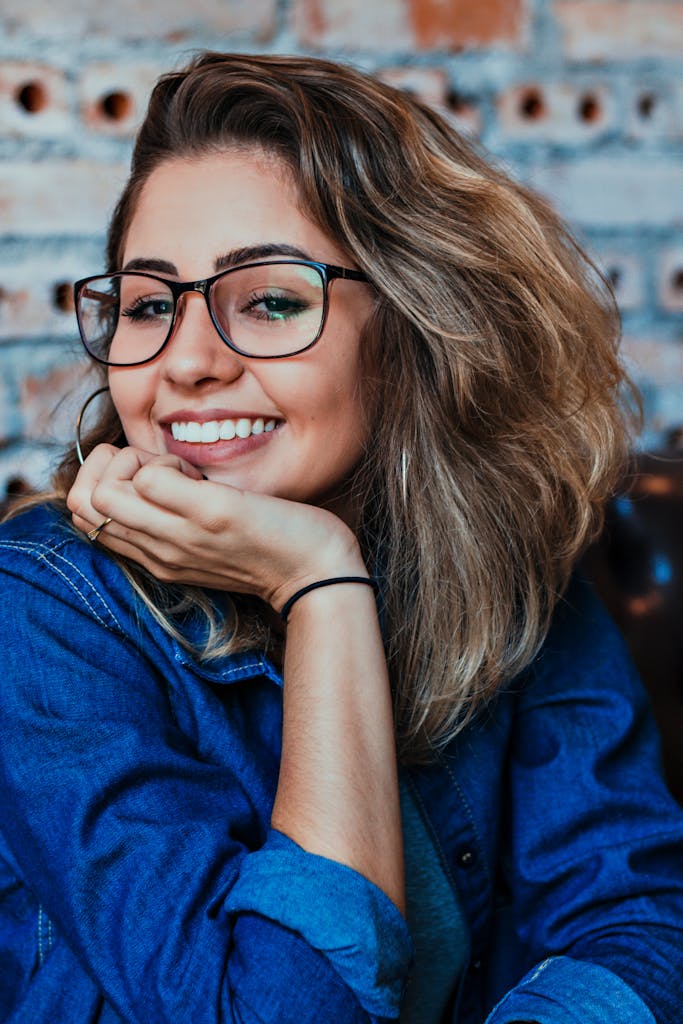 Closeup Photo of Smiling Woman Wearing Blue Denim Jacket