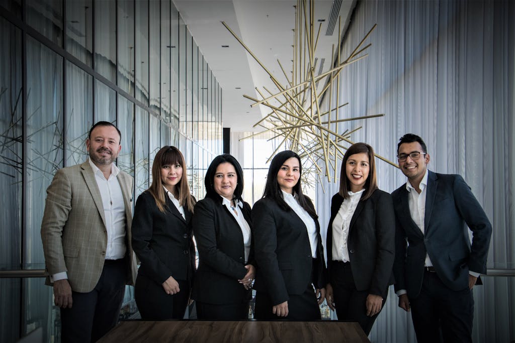 Plan Corporate Headshots Diverse business team in formal attire posed in modern office.