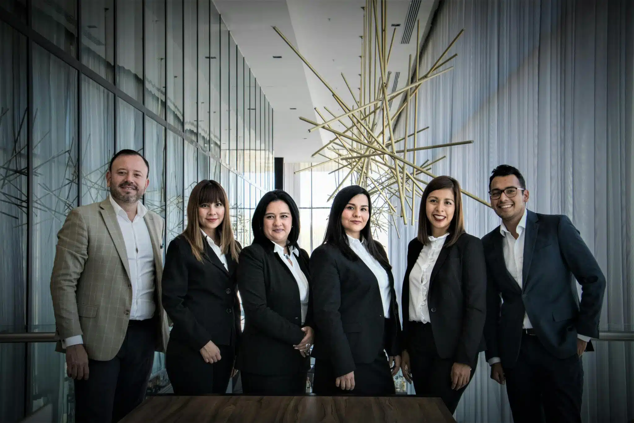Plan Corporate Headshots: 8 Steps for Seamless Company Portraits 19 Plan Corporate Headshots Diverse business team in formal attire posed in modern office.