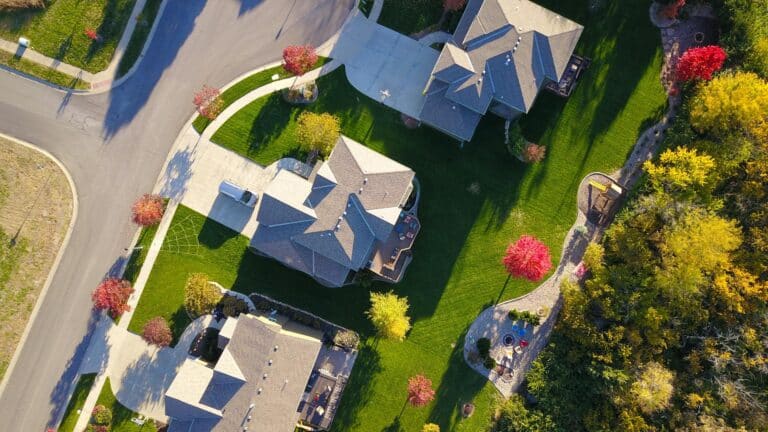 professional headshots for realtors on Zillow A picturesque aerial view showcasing suburban homes with vibrant gardens and tree-lined streets.
