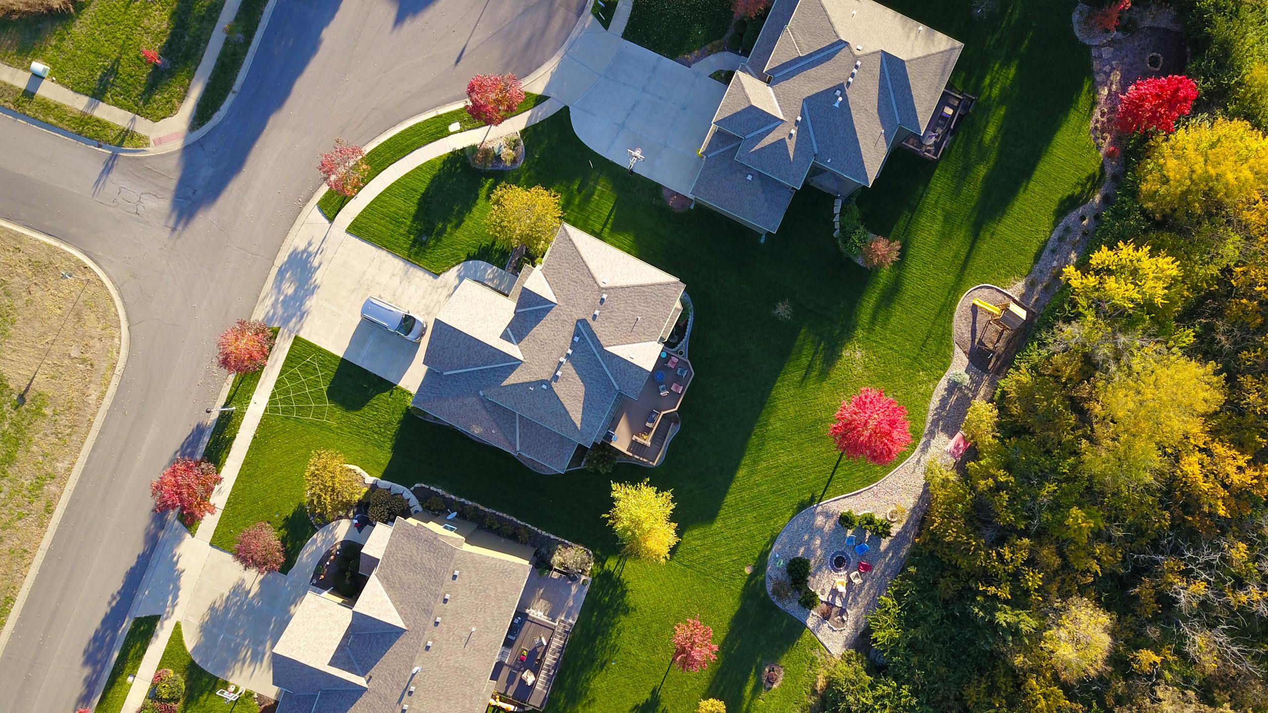 professional headshots for realtors on Zillow A picturesque aerial view showcasing suburban homes with vibrant gardens and tree-lined streets.