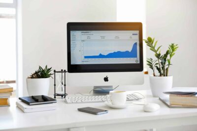 Best CRM for Small Business Owners 95 A clean, contemporary workspace featuring a desktop with analytics on the screen and plants for a fresh look. best CRM for small business owners
