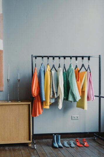 Branding Session Outfit Changes: How to Plan for Multiple Looks 13 branding session outfit changes A vibrant clothes rack with colorful outfits in a minimalist room setting.