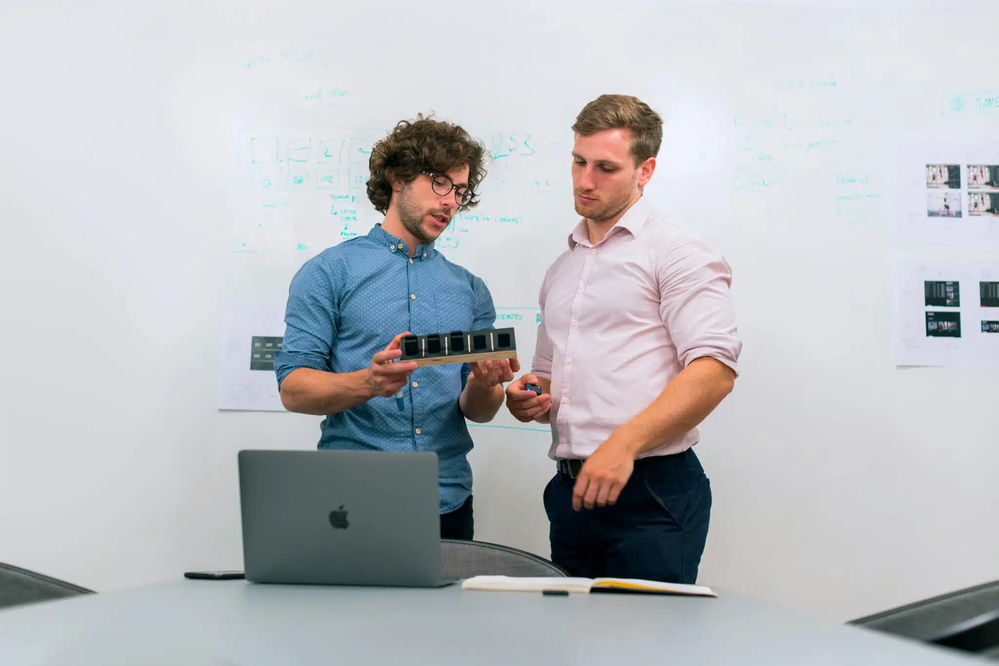 How to Plan Your Branding Session for Launch of a Product or Service 8 Two men in an office discussing and reviewing a tech prototype. Branding Session for Launch