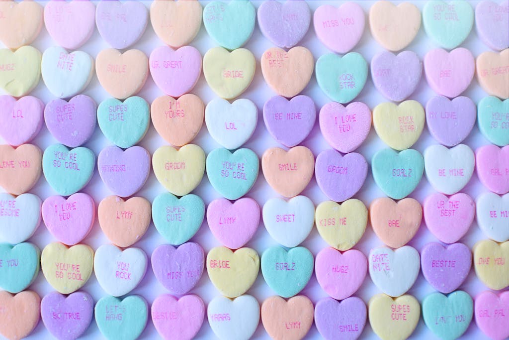 Boudoir referral program | Brightly colored heart-shaped candies with sweet messages, perfect for Valentine's Day.