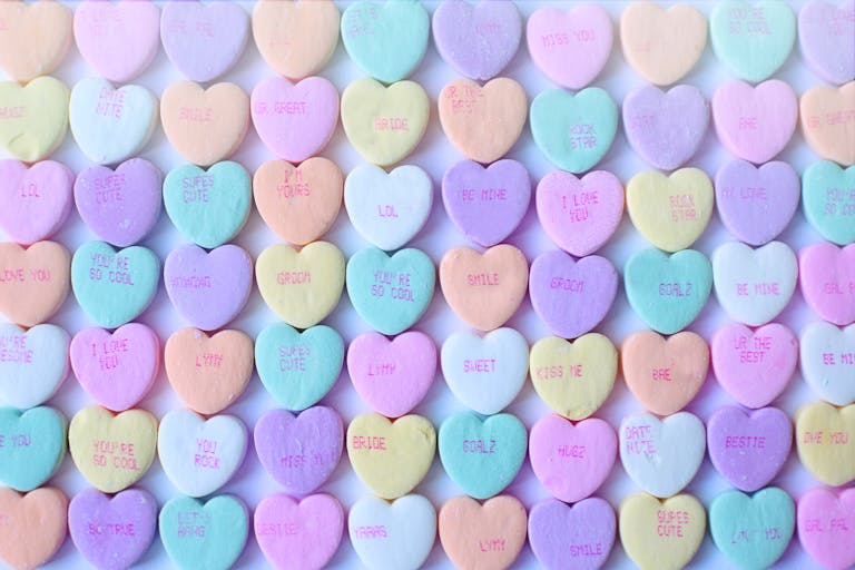 Boudoir referral program | Brightly colored heart-shaped candies with sweet messages, perfect for Valentine's Day.