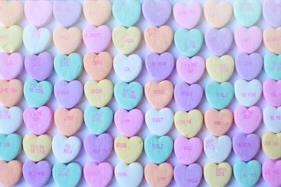 Boudoir referral program | Brightly colored heart-shaped candies with sweet messages, perfect for Valentine's Day.