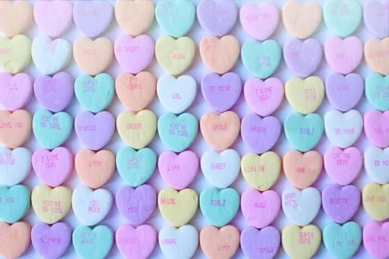 Boudoir referral program | Brightly colored heart-shaped candies with sweet messages, perfect for Valentine's Day.