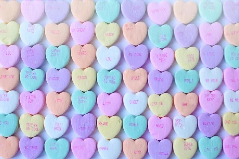 Boudoir referral program | Brightly colored heart-shaped candies with sweet messages, perfect for Valentine's Day.
