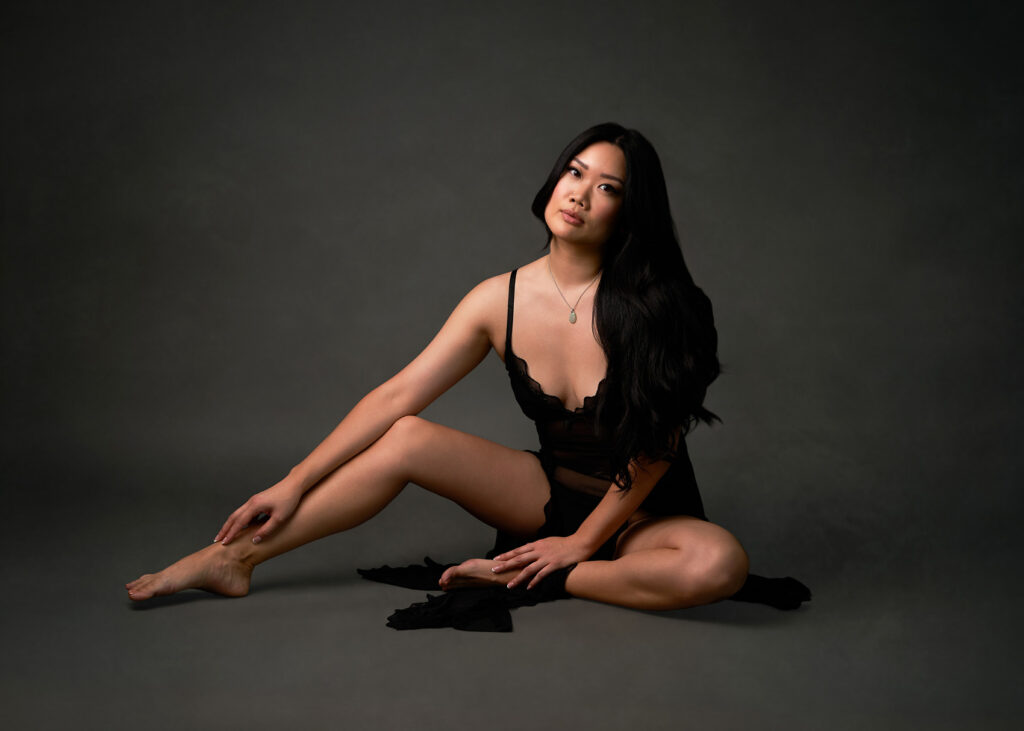 Sophisticated seated boudoir portrait with sculpted lighting by Austin boudoir photographer