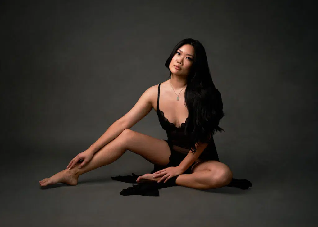 Sophisticated seated boudoir portrait with sculpted lighting by Austin boudoir photographer